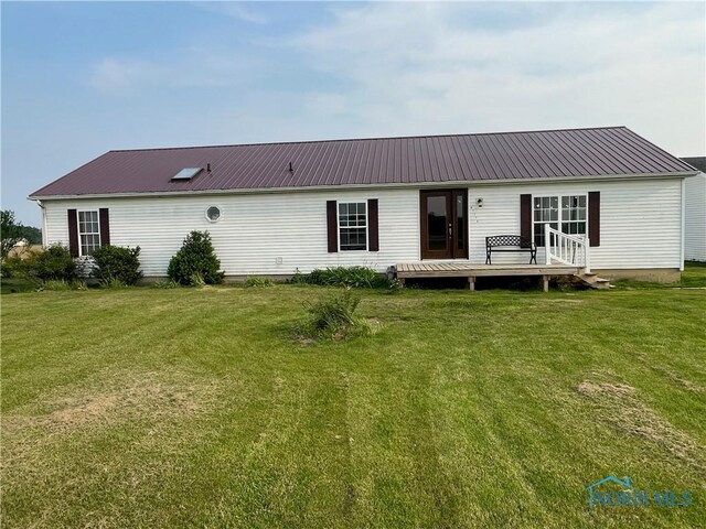 7774 Scott Rd, Edgerton, OH 43517 - back of house with a deck, a lawn, and metal roof