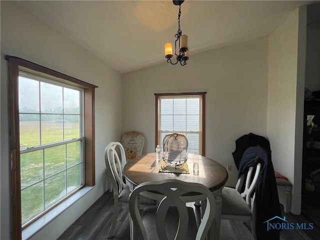 7774 Scott Rd, Edgerton, OH 43517 - dining area featuring dark wood-style flooring, vaulted ceiling, and a chandelier