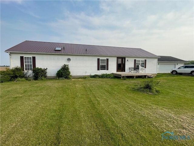 7774 Scott Rd, Edgerton, OH 43517 - view of front of house featuring a wooden deck, a front lawn, and metal roof