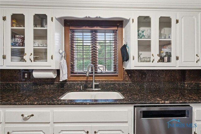 2917 Goddard Rd, Toledo, OH 43606 - kitchen featuring stainless steel dishwasher, glass insert cabinets, backsplash, and white cabinets