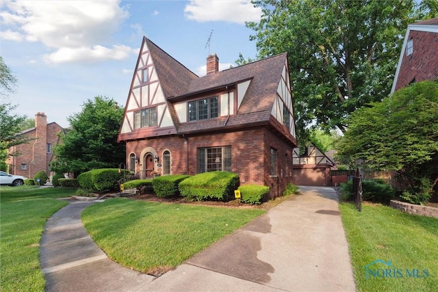 2917 Goddard Rd, Toledo, OH 43606 - english style home featuring brick siding, a front yard, and a chimney