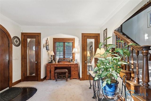 2917 Goddard Rd, Toledo, OH 43606 - entryway featuring arched walkways, light carpet, and ornamental molding