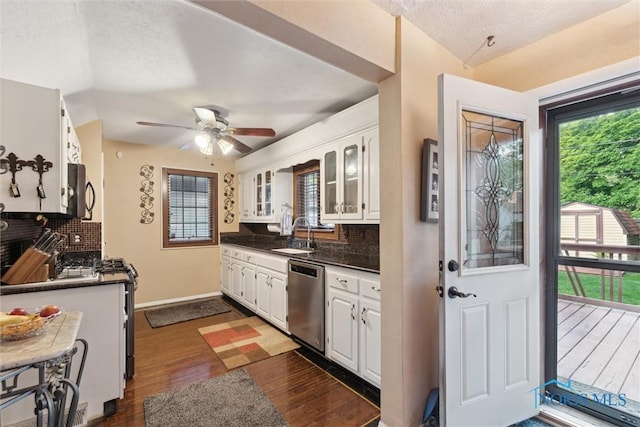 2917 Goddard Rd, Toledo, OH 43606 - kitchen with dishwasher, dark countertops, white cabinetry, and a textured ceiling