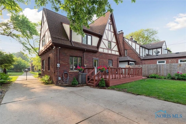 2917 Goddard Rd, Toledo, OH 43606 - back of property featuring brick siding, a deck, and roof with shingles