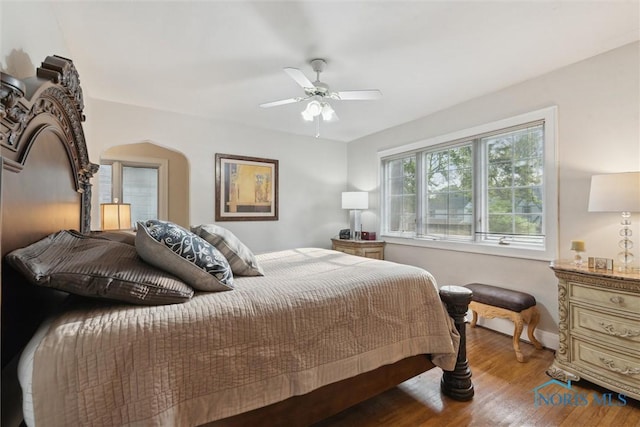 2917 Goddard Rd, Toledo, OH 43606 - bedroom featuring wood finished floors, a ceiling fan, and arched walkways