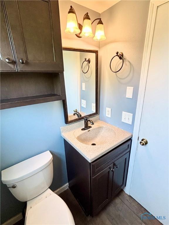1105 S Lallendorf Rd, Oregon, OH 43616 - bathroom featuring vanity and wood finished floors