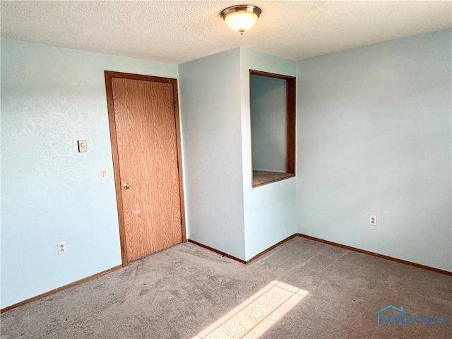 1105 S Lallendorf Rd, Oregon, OH 43616 - carpeted spare room with a textured ceiling and baseboards