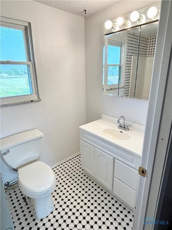 1105 S Lallendorf Rd, Oregon, OH 43616 - bathroom with vanity, plenty of natural light, and a textured ceiling