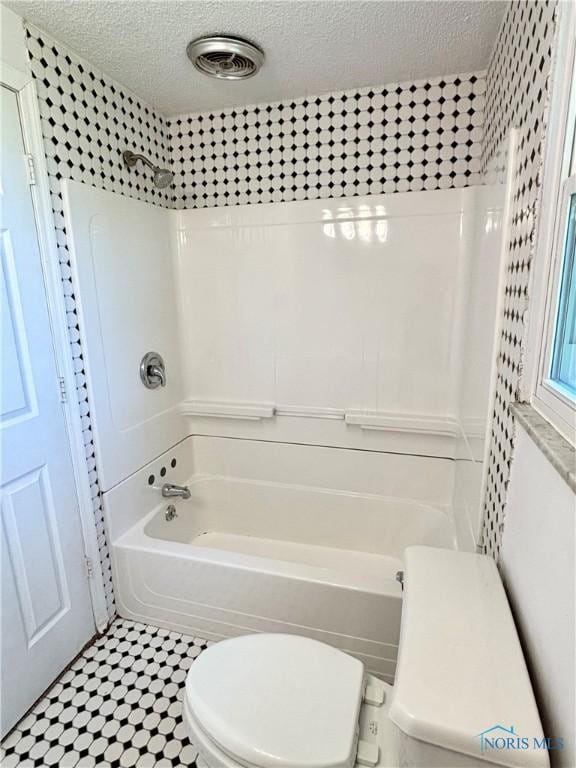 1105 S Lallendorf Rd, Oregon, OH 43616 - bathroom featuring a textured ceiling and tub / shower combination