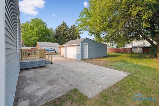 1006 Brookley Blvd, Toledo, OH 43607 - view of patio featuring a detached garage, an outdoor structure, and a deck