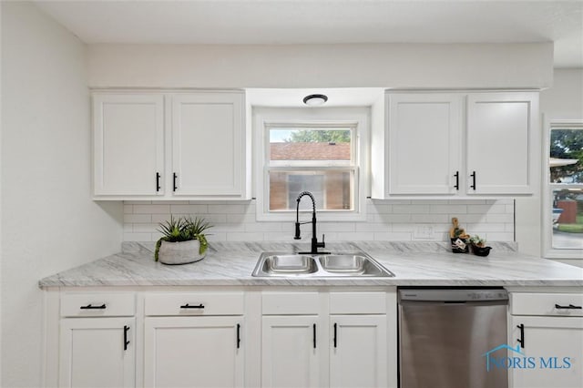 1006 Brookley Blvd, Toledo, OH 43607 - kitchen featuring stainless steel dishwasher, a sink, backsplash, and white cabinetry