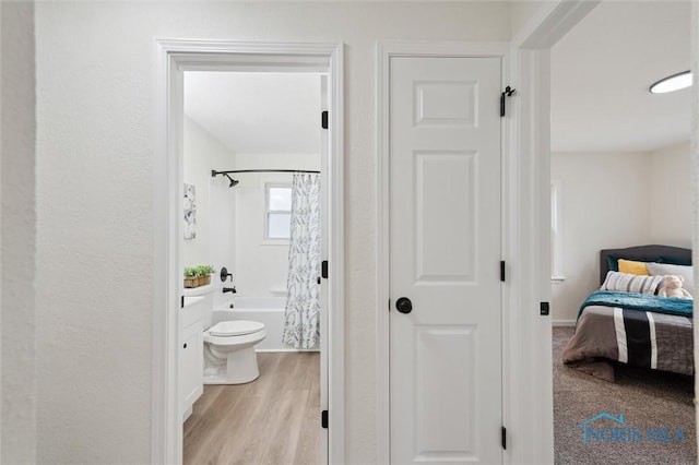 1006 Brookley Blvd, Toledo, OH 43607 - bathroom with toilet, shower / bath combo, ensuite bathroom, and wood finished floors