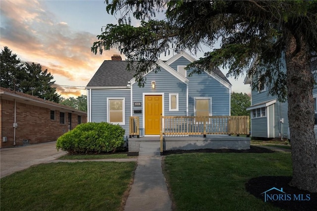 1006 Brookley Blvd, Toledo, OH 43607 - view of front of property featuring a front yard, a porch, a chimney, and a shingled roof