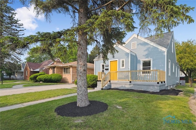 1006 Brookley Blvd, Toledo, OH 43607 - view of front of house with a front yard, central AC, and concrete driveway