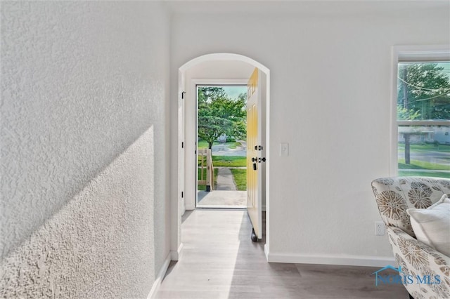 1006 Brookley Blvd, Toledo, OH 43607 - entryway with plenty of natural light, arched walkways, wood finished floors, baseboards, and a textured wall