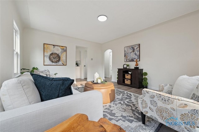 1006 Brookley Blvd, Toledo, OH 43607 - living room with arched walkways, wood finished floors, and baseboards