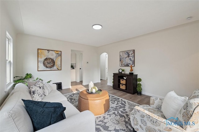1006 Brookley Blvd, Toledo, OH 43607 - living room featuring arched walkways, wood finished floors, and baseboards