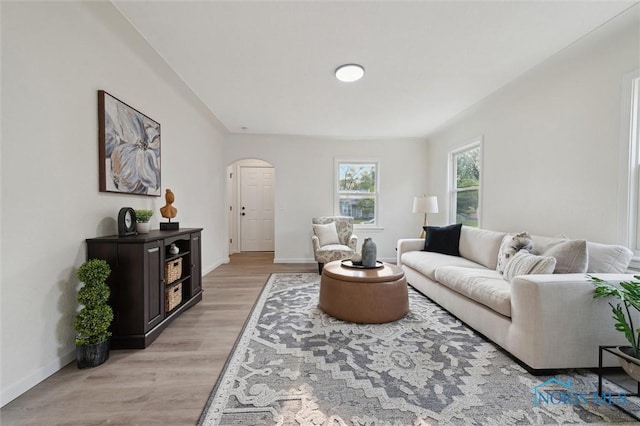 1006 Brookley Blvd, Toledo, OH 43607 - living area featuring arched walkways, light wood-style floors, and baseboards