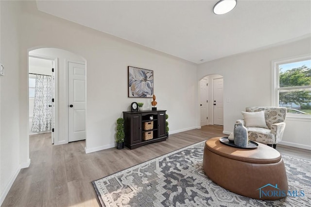1006 Brookley Blvd, Toledo, OH 43607 - sitting room with arched walkways, wood finished floors, and baseboards