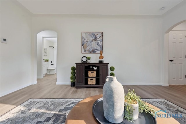 1006 Brookley Blvd, Toledo, OH 43607 - living room with arched walkways, wood finished floors, and baseboards