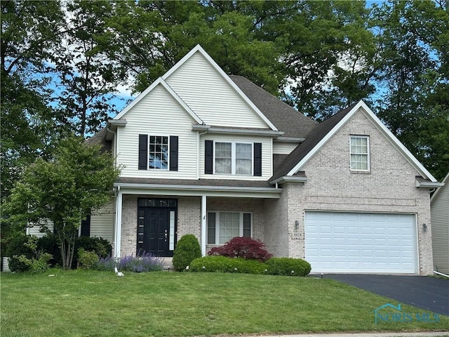 8828 Cedar Bend Rd, Sylvania, OH 43560 - traditional home featuring an attached garage, driveway, a front lawn, and brick siding