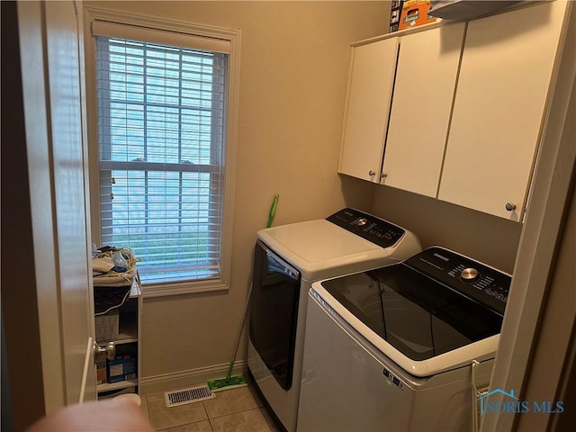 8828 Cedar Bend Rd, Sylvania, OH 43560 - laundry room with cabinet space, washer and dryer, and light tile patterned floors
