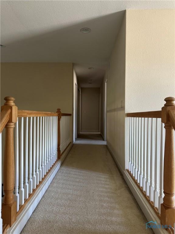 8828 Cedar Bend Rd, Sylvania, OH 43560 - hall with carpet flooring and an upstairs landing