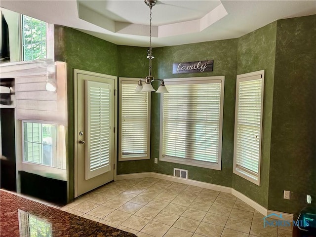 8828 Cedar Bend Rd, Sylvania, OH 43560 - unfurnished dining area featuring a tray ceiling, plenty of natural light, and light tile patterned floors