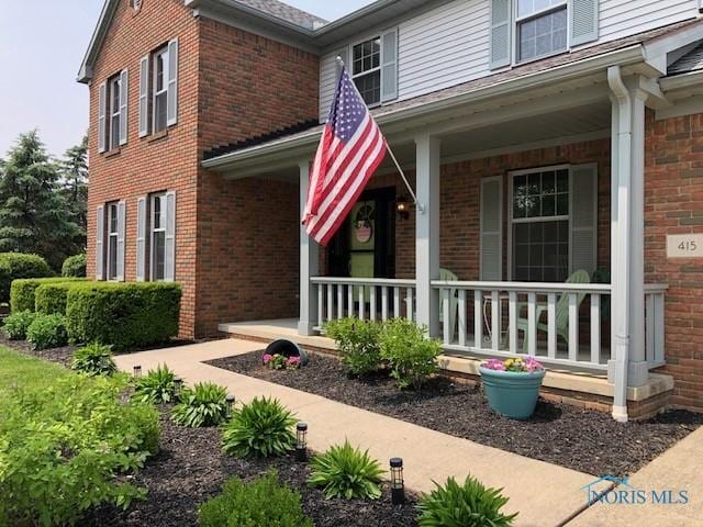 415 W Jamestown Ave, Tiffin, OH 44883 - property entrance featuring covered porch and brick siding