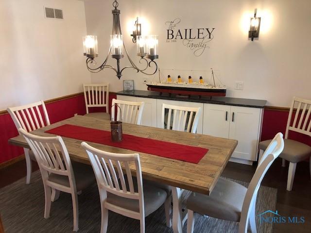 415 W Jamestown Ave, Tiffin, OH 44883 - dining space with a chandelier and dark wood-type flooring