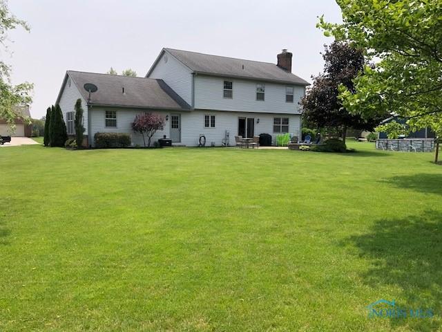 415 W Jamestown Ave, Tiffin, OH 44883 - back of property featuring a chimney and a yard