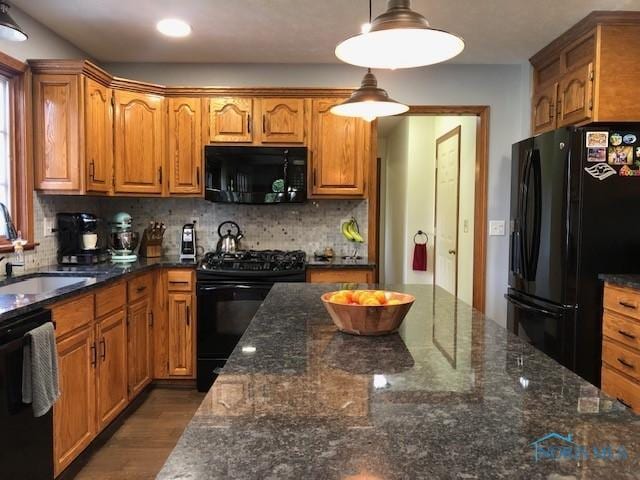 415 W Jamestown Ave, Tiffin, OH 44883 - kitchen with black appliances, a sink, brown cabinets, tasteful backsplash, and recessed lighting