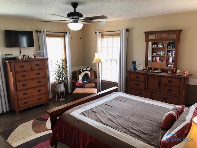 415 W Jamestown Ave, Tiffin, OH 44883 - bedroom with multiple windows, a textured ceiling, and ceiling fan