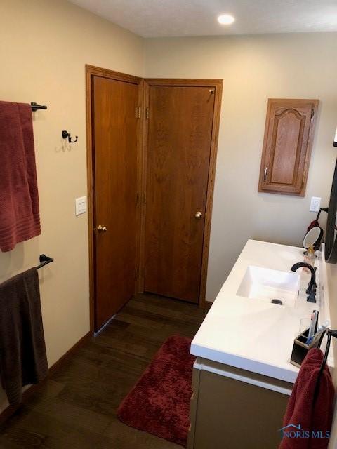 415 W Jamestown Ave, Tiffin, OH 44883 - bathroom with wood finished floors, vanity, and recessed lighting