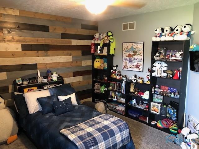 415 W Jamestown Ave, Tiffin, OH 44883 - bedroom featuring carpet flooring and wooden walls