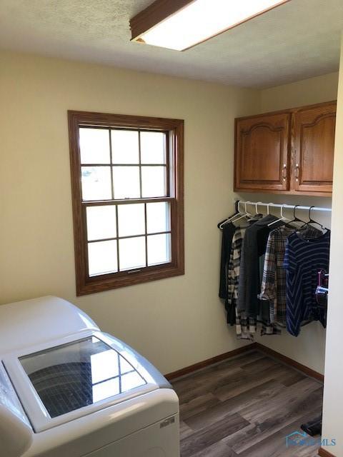 415 W Jamestown Ave, Tiffin, OH 44883 - laundry room featuring cabinet space, dark wood-style flooring, baseboards, and separate washer and dryer