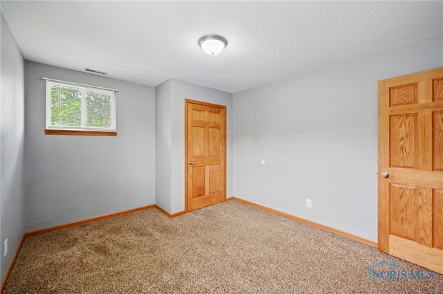 536 N Johnson St, Ada, OH 45810 - carpeted empty room with baseboards