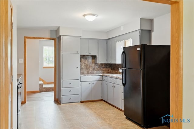 536 N Johnson St, Ada, OH 45810 - kitchen with freestanding refrigerator, decorative backsplash, gray cabinets, and electric range oven
