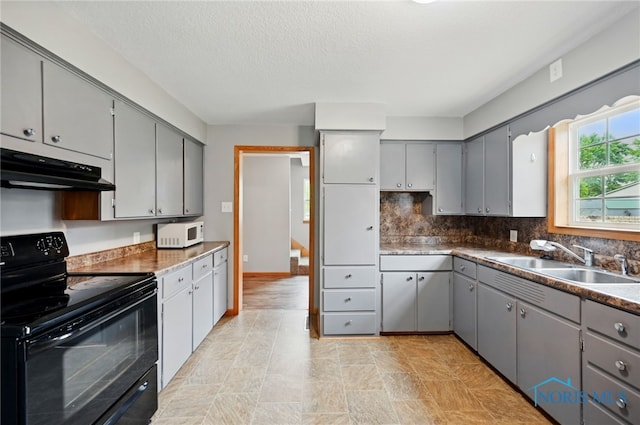 536 N Johnson St, Ada, OH 45810 - kitchen with black range with electric cooktop, a sink, gray cabinetry, ventilation hood, and a textured ceiling