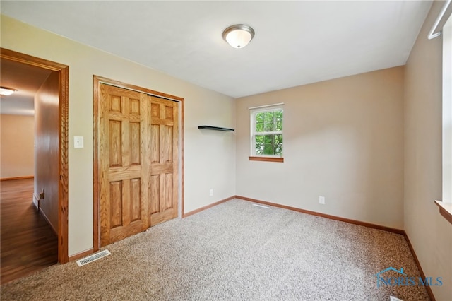 536 N Johnson St, Ada, OH 45810 - unfurnished bedroom with carpet flooring, baseboards, and a closet
