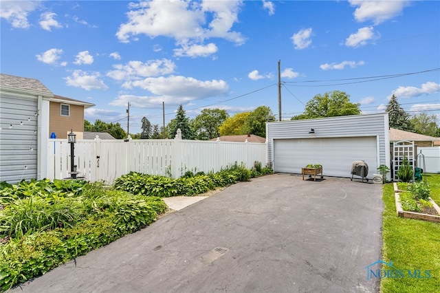 713 N Vine St, Fostoria, OH 44830 - view of patio with an outbuilding and a detached garage