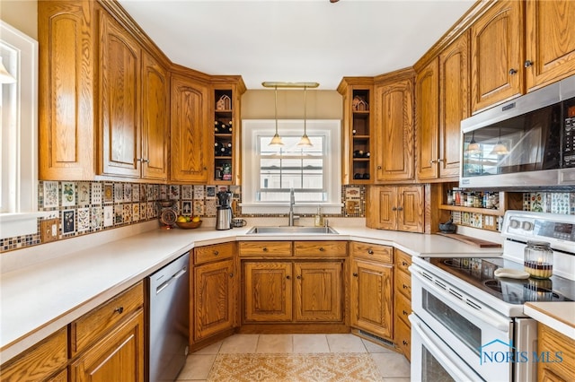 713 N Vine St, Fostoria, OH 44830 - kitchen featuring appliances with stainless steel finishes, open shelves, a sink, and brown cabinets