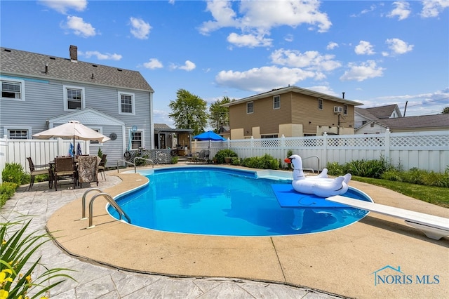 713 N Vine St, Fostoria, OH 44830 - view of swimming pool featuring a patio area and a diving board