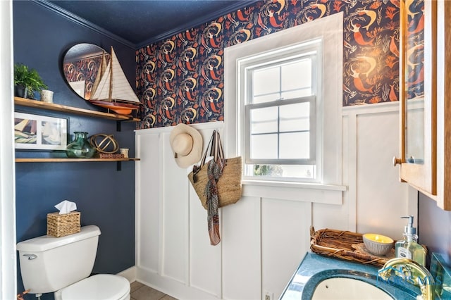 713 N Vine St, Fostoria, OH 44830 - bathroom featuring wallpapered walls, crown molding, a sink, toilet, and a wainscoted wall