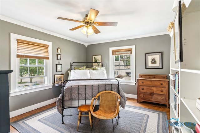 713 N Vine St, Fostoria, OH 44830 - bedroom featuring crown molding, wood finished floors, baseboards, and a ceiling fan