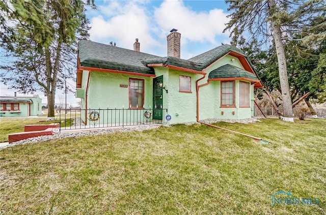 7149 Wales Rd, Northwood, OH 43619 - back of property with stucco siding, a chimney, a lawn, and roof with shingles