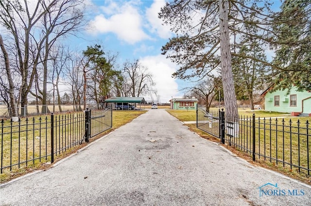 7149 Wales Rd, Northwood, OH 43619 - view of asphalt driveway featuring a gated entry and a gate