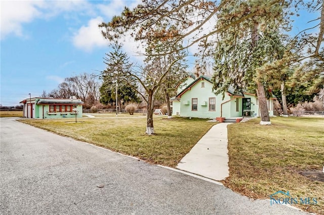 7149 Wales Rd, Northwood, OH 43619 - view of front of property with a front lawn and stucco siding