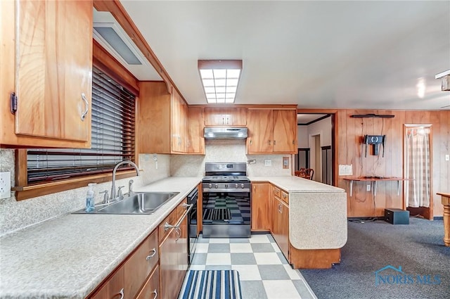 7149 Wales Rd, Northwood, OH 43619 - kitchen with gas range, a sink, under cabinet range hood, light countertops, and a peninsula