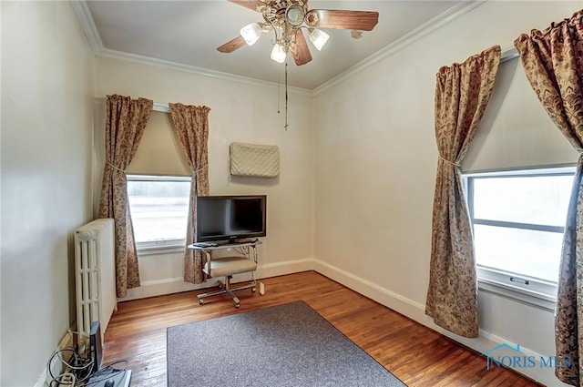 7149 Wales Rd, Northwood, OH 43619 - interior space with radiator, wood finished floors, ornamental molding, a ceiling fan, and baseboards